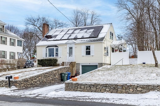 view of front of property featuring solar panels