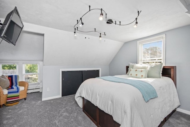 carpeted bedroom with multiple windows, baseboards, vaulted ceiling, and baseboard heating