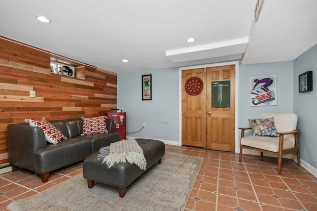 living area featuring wood walls, baseboards, and recessed lighting
