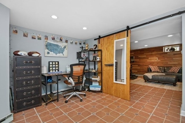 office area featuring a baseboard heating unit, wooden walls, a barn door, and recessed lighting