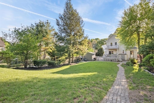 view of green lawn featuring a wooden deck