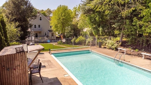view of pool with fence and a patio area