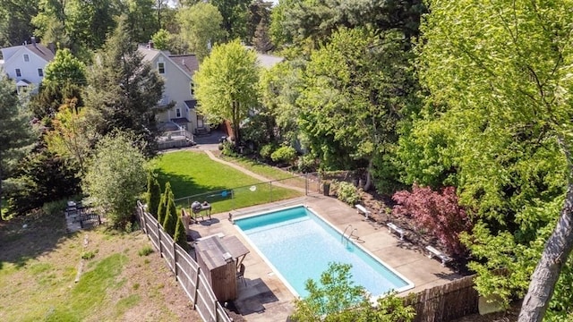 bird's eye view of a pool and a tree filled landscape