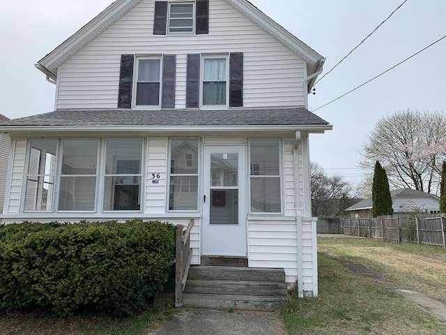 view of front of home with entry steps and a shingled roof
