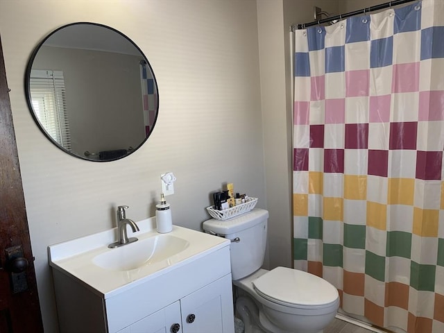 bathroom featuring vanity, toilet, and a shower with curtain