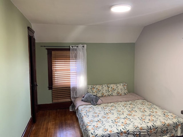 bedroom featuring hardwood / wood-style flooring and vaulted ceiling
