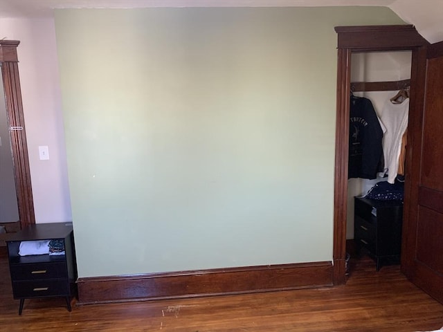 bedroom with wood finished floors and baseboards