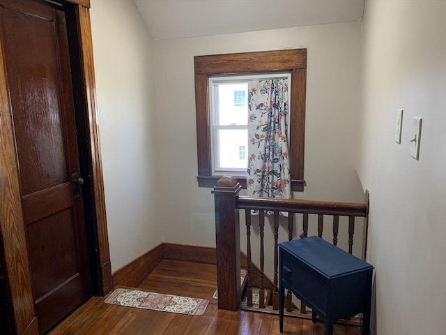 stairs featuring wood finished floors and baseboards