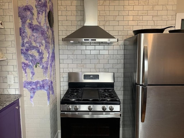 kitchen with appliances with stainless steel finishes, wall chimney range hood, and stone countertops
