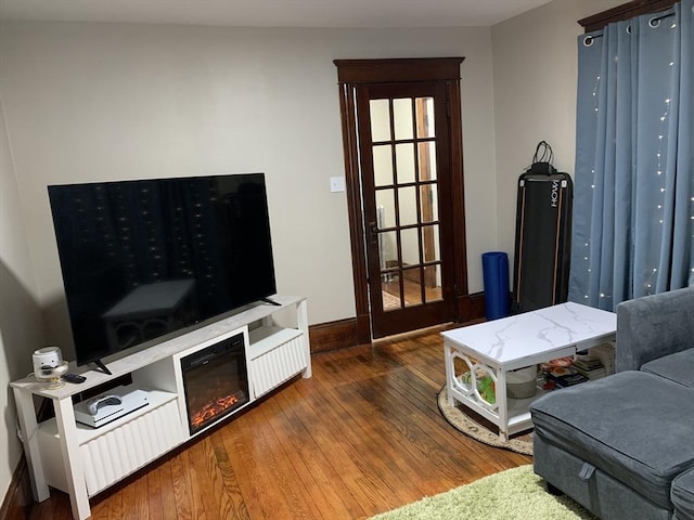 living area with wood finished floors and baseboards