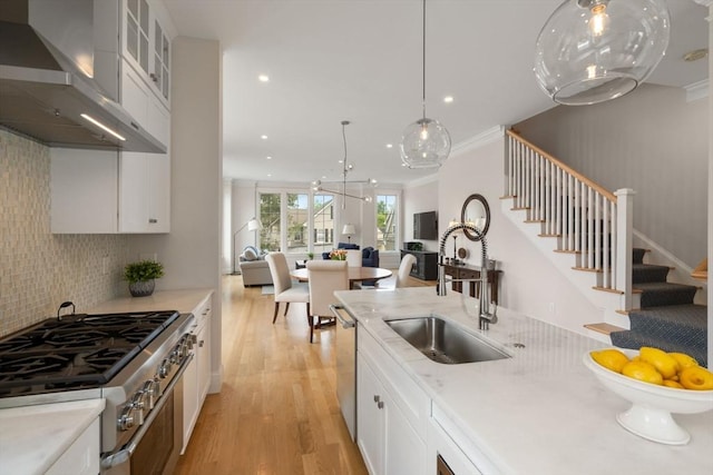 68 Summer St Unit B, Natick, MA 01760 - kitchen with wall chimney range hood, stainless steel dishwasher, a sink, light wood-type flooring, and open floor plan