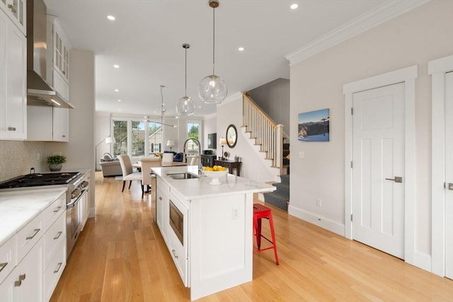 68 Summer St Unit B, Natick, MA 01760 - kitchen featuring wall chimney range hood, a sink, open floor plan, stainless steel range, and ornamental molding