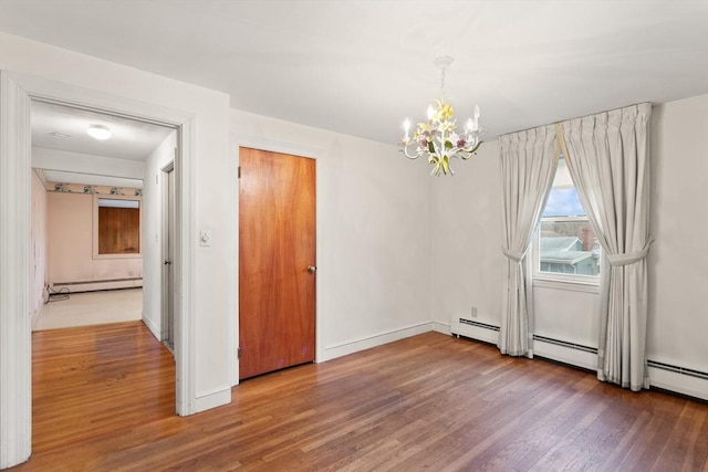 unfurnished dining area with a baseboard radiator, baseboards, an inviting chandelier, and wood finished floors