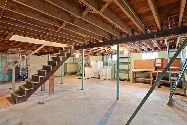 basement with washer and dryer, stairway, and heating fuel