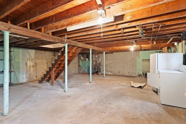 unfinished basement with stairway and washer / clothes dryer