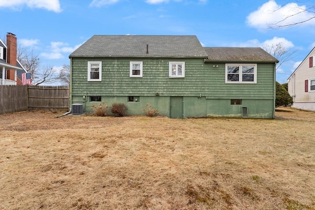 back of house with central AC and fence