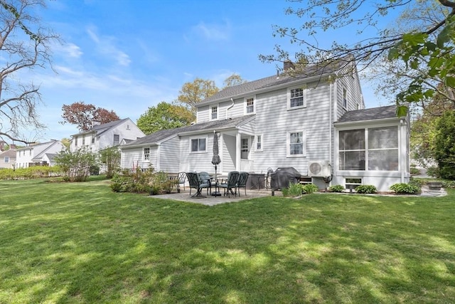 118 Academy Ave, Weymouth, MA 02188 - back of property featuring a patio area, a sunroom, a lawn, and a chimney