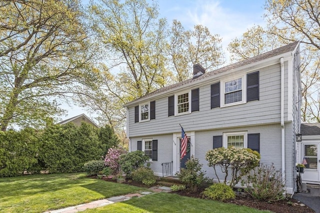 118 Academy Ave, Weymouth, MA 02188 - colonial-style house featuring a chimney, brick siding, and a front lawn