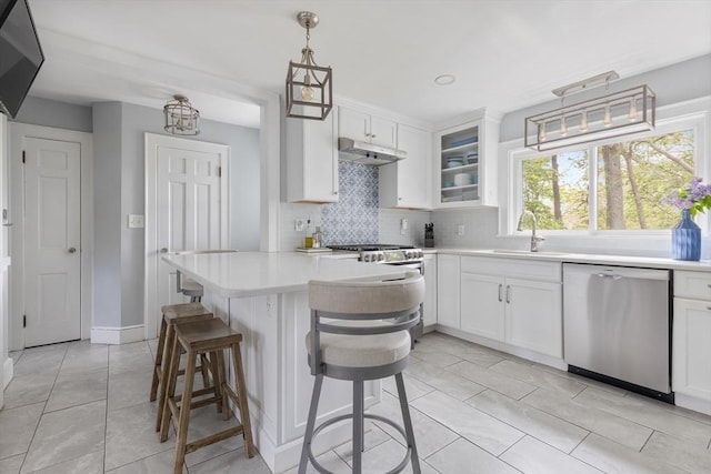 118 Academy Ave, Weymouth, MA 02188 - kitchen with stainless steel appliances, light countertops, tasteful backsplash, light tile patterned flooring, and glass insert cabinets