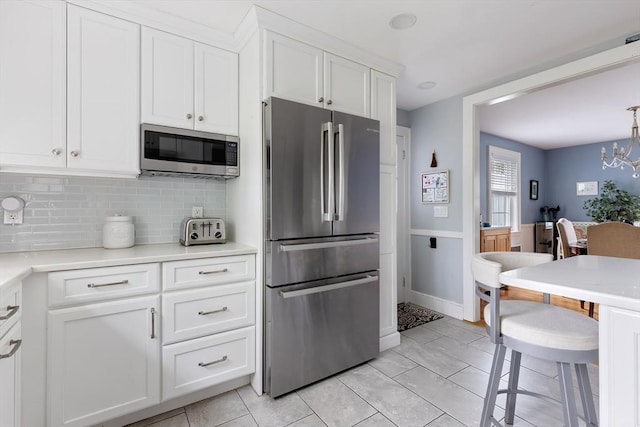 118 Academy Ave, Weymouth, MA 02188 - kitchen with appliances with stainless steel finishes, backsplash, white cabinets, light countertops, and light tile patterned flooring