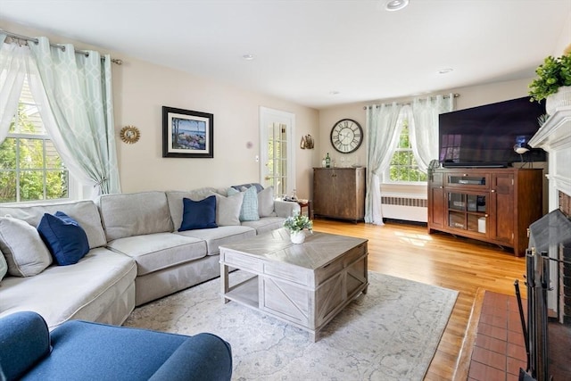 118 Academy Ave, Weymouth, MA 02188 - living area with radiator heating unit, a fireplace, wood finished floors, and recessed lighting