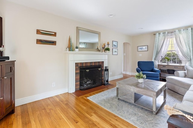 118 Academy Ave, Weymouth, MA 02188 - living room with arched walkways, light wood finished floors, baseboards, a fireplace, and recessed lighting