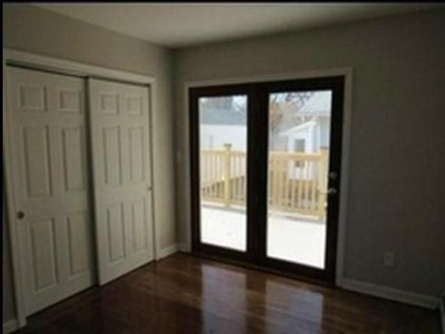 doorway with dark hardwood / wood-style floors