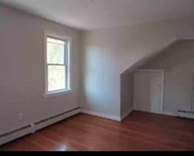 bonus room featuring hardwood / wood-style floors and baseboard heating