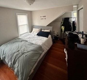 bedroom with dark wood-type flooring