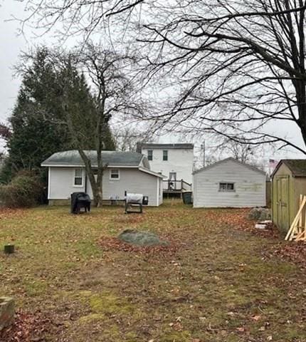 back of property with a shed