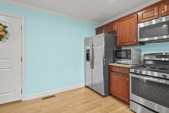 41 Belmont Ave Unit 41, Haverhill, MA 01830 - kitchen with stainless steel appliances, light wood-style floors, crown molding, baseboards, and brown cabinets