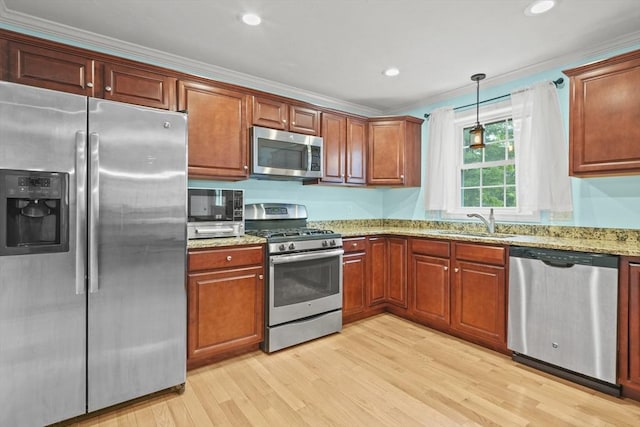 41 Belmont Ave Unit 41, Haverhill, MA 01830 - kitchen featuring stainless steel appliances, a sink, light wood-style flooring, light stone counters, and crown molding