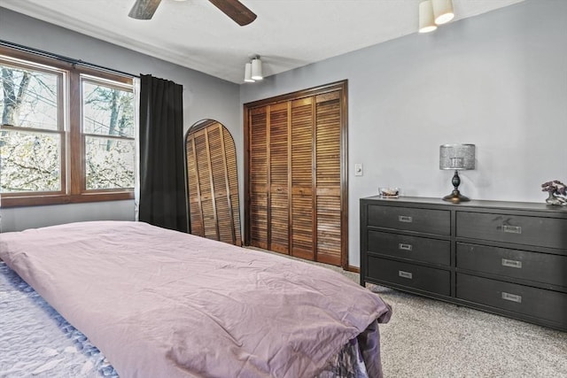 bedroom featuring light colored carpet and ceiling fan