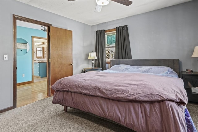 carpeted bedroom with baseboards and a ceiling fan