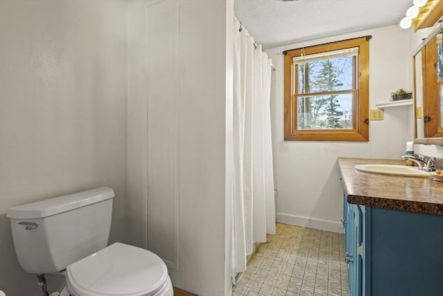 full bath featuring baseboards, tile patterned floors, toilet, and vanity