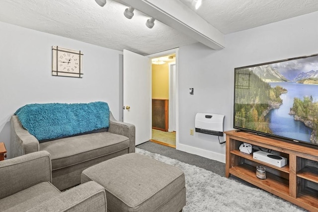 living room featuring baseboards, heating unit, a textured ceiling, and carpet flooring