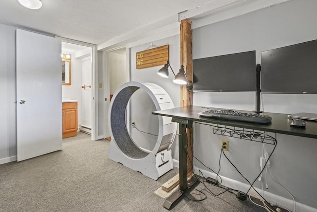 washroom featuring baseboards, light carpet, and a baseboard heating unit