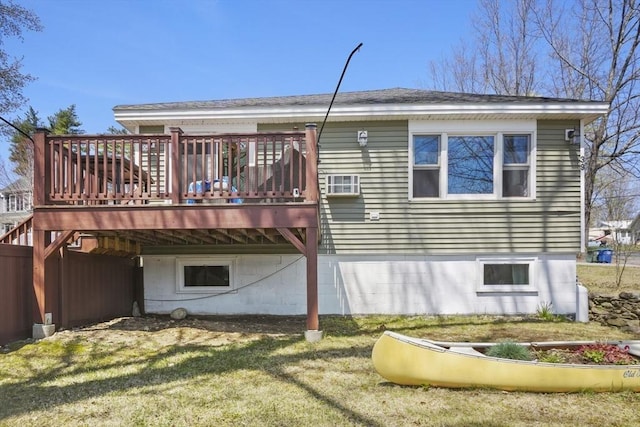 rear view of house with a lawn and a wooden deck