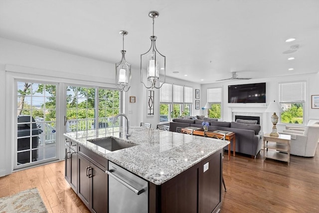 kitchen with pendant lighting, sink, stainless steel dishwasher, ceiling fan, and dark brown cabinets