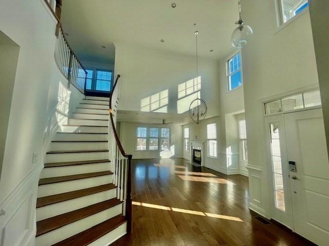 entrance foyer with plenty of natural light, dark wood-type flooring, and a high ceiling