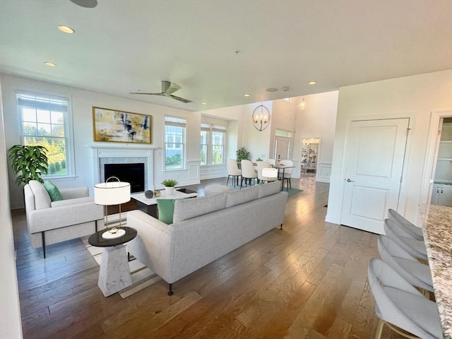 living room featuring ceiling fan and dark wood-type flooring