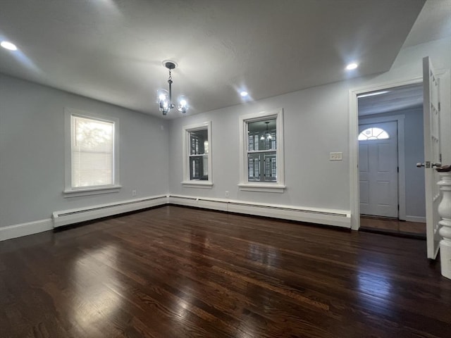 interior space featuring dark wood-type flooring, a chandelier, and baseboard heating