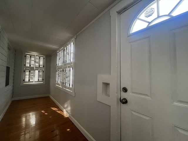 interior space with plenty of natural light, mail boxes, and dark hardwood / wood-style flooring