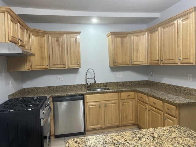 kitchen featuring light tile patterned flooring, appliances with stainless steel finishes, sink, and dark stone counters