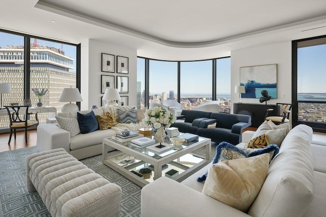 living room featuring a wealth of natural light, floor to ceiling windows, and wood finished floors