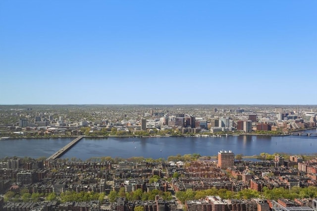 birds eye view of property featuring a water view and a city view