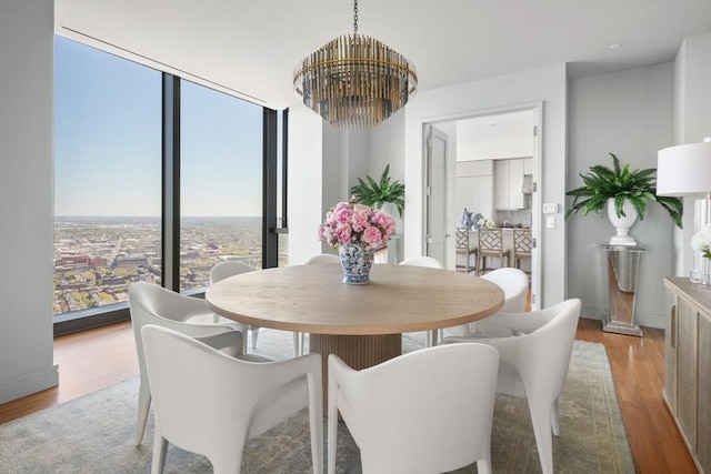 dining room with a notable chandelier and light wood-type flooring