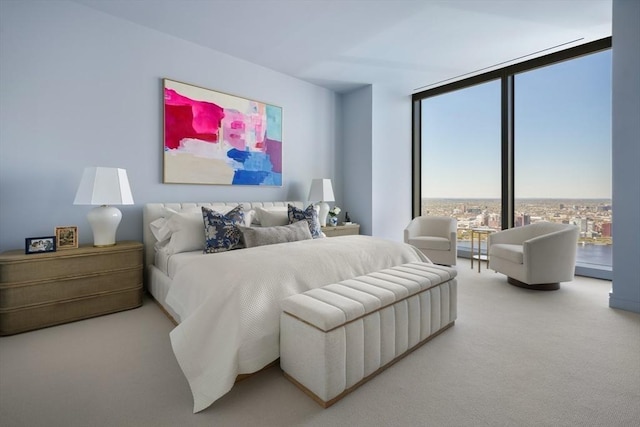 bedroom with a wall of windows and carpet