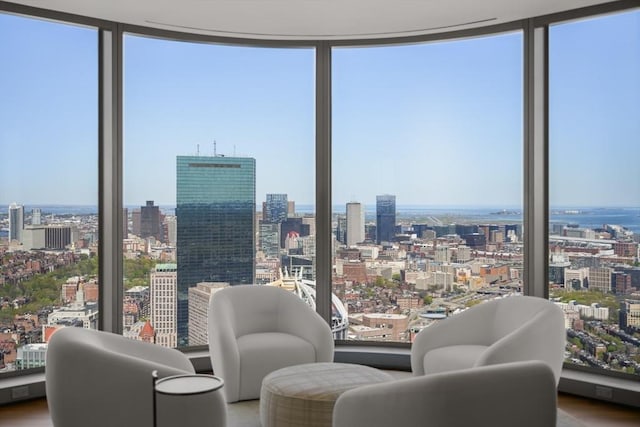 sitting room featuring a city view, a wall of windows, and plenty of natural light