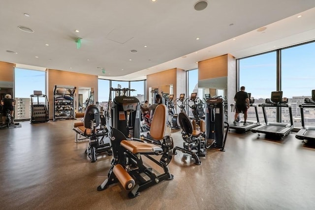 exercise room with recessed lighting, a healthy amount of sunlight, and floor to ceiling windows